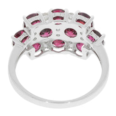 Sterling silver ring featuring multiple pink gemstones, showcasing intricate design and elegant craftsmanship.