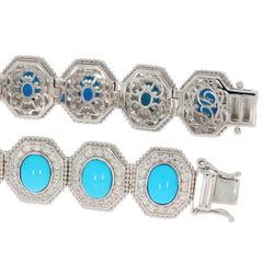Oval blue turquoise sterling silver bracelet with intricate designs and elegant gemstones.