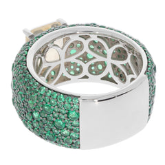 Elegant sterling silver ring encrusted with vibrant green gemstones, featuring a unique design for a sophisticated look.