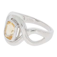 Elegant silver ring featuring a cushion-cut yellow gemstone in a unique design.