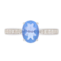 Elegant blue gemstone ring in sterling silver with accent stones, perfect for adding a touch of luxury to your collection.