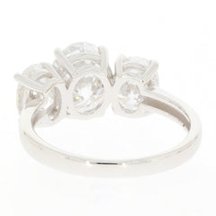 Elegant white moissanite sterling silver ring with three sparkling gemstones, showcasing timeless beauty and brilliance.