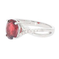 Red garnet sterling silver ring with diamond accents, showcasing elegance and luxury.