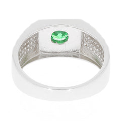 Round green emerald set in a sleek sterling silver ring, showcasing elegant craftsmanship and luxury.