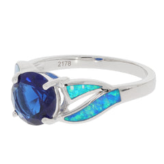 Blue sapphire sterling silver ring with opal accents, showcasing an elegant design in a luxurious setting.