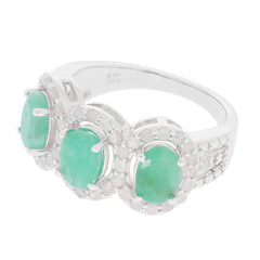 Elegant sterling silver ring featuring three oval green emeralds surrounded by sparkling accents.