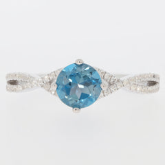 Round blue London Topaz sterling silver ring with accent diamonds, showcasing elegance and luxury.