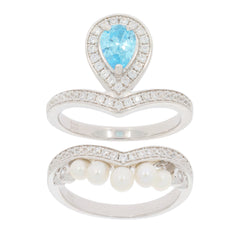 Pear-shaped blue topaz ring set in sterling silver with a band of pearls and accent diamonds.