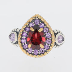 Pear shaped red garnet sterling silver ring with amethyst accents, showcasing luxurious elegance and intricate design.