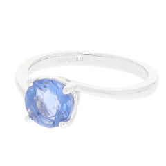 Elegant round blue sapphire ring in sterling silver setting, showcasing the gemstone's brilliance and luxury.