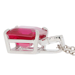 Emerald cut red ruby pendant in sterling silver setting with intricate design, highlighting its luxury and elegance.