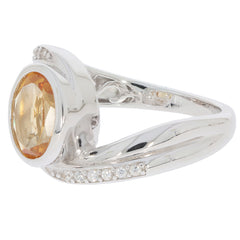 Oval yellow citrine sterling silver ring with moissanite accents, showcasing elegant design and sparkling gemstones.