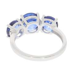 Elegant blue tanzanite sterling silver ring showcasing sparkling gemstones from the side view.