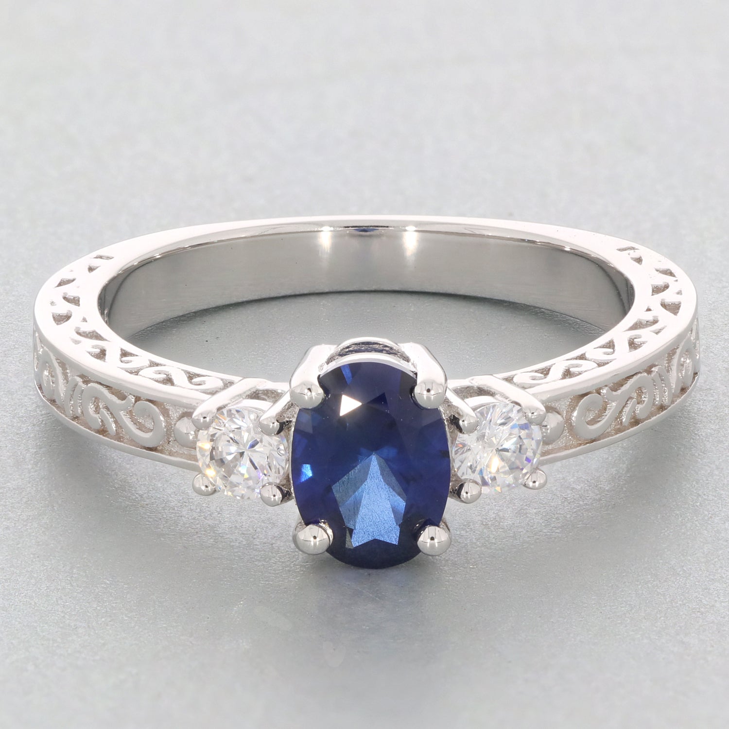 Blue Moissanite sterling silver ring with accent stones, showcasing elegant design and luxurious gemstone brilliance.