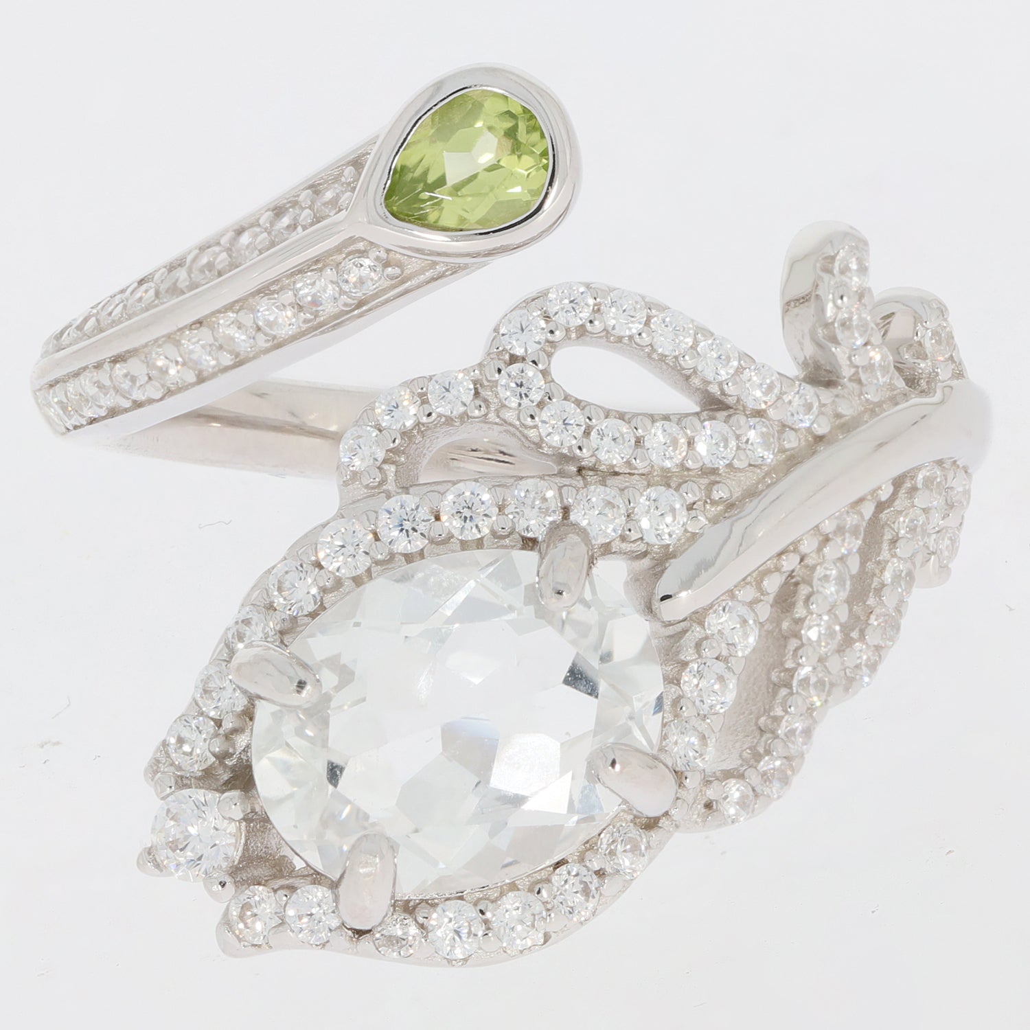 Oval green peridot and moissanite sterling silver ring showcasing intricate design and elegant sparkle.