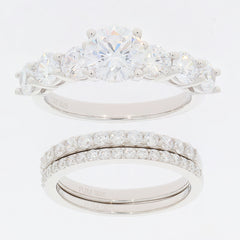 Round white Moissanite sterling silver ring set featuring a sparkling accent piece and elegant design.