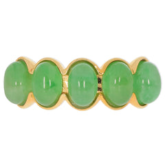 Elegant green jade ring with gold accents, featuring multiple oval jade gemstones for a sophisticated touch.