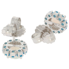 Round white opal sterling silver earrings with blue accents, showcasing intricate design and shimmering gemstones.
