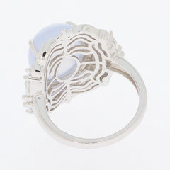 Elegant sterling silver ring featuring an oval white opal and moissanite accents, showcasing intricate design details.