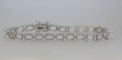 Sterling silver semi mount tennis bracelet setting with oval spaces for stones, crafted for customizable fit.