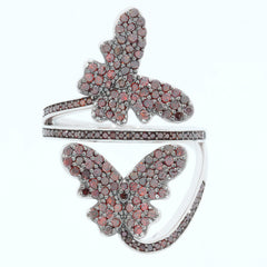 Elegant sterling silver butterfly ring adorned with sparkling red diamonds, showcasing intricate design and luxury.
