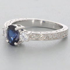 Blue Moissanite sterling silver ring with intricate design and accent stones, showcasing elegance and luxury.