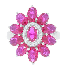 Oval pink sapphire sterling silver ring surrounded by accent stones, a luxurious addition to any jewelry collection.
