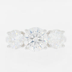 Elegant three-stone ring featuring brilliant round cut diamonds set in white gold, perfect for any occasion.