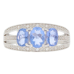 Blue Tanzanite sterling silver ring with three oval stones and sparkling accents, perfect for elegant jewelry collections.