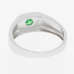 Sterling silver ring featuring a round green emerald gemstone set on the side, showcasing its elegant design.