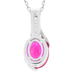 Oval red ruby sterling silver pendant with moissanite accent, showcasing vibrant red gemstone and elegant design.