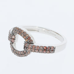 Elegant sterling silver ring with red diamond accents, featuring a unique intertwined design.