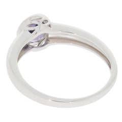 Round blue topaz sterling silver ring with moissanite accent showcasing elegant design from the side.