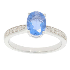 Blue gemstone silver ring with diamond accents, featuring an oval-cut blue stone and elegant band design.