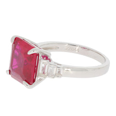 Emerald red ruby sterling silver ring with moissanite accent, showcasing elegance and luxury in design.