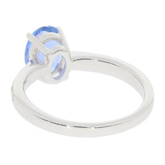 Side view of a sterling silver ring featuring a large blue gemstone, showcasing its elegant design.