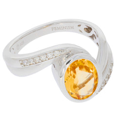 Elegant oval yellow citrine sterling silver ring with moissanite accents, symbolizing luxury and sophistication.