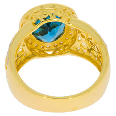 Oval blue topaz sterling silver ring with intricate design and moissanite accent, showcasing luxury and elegance.