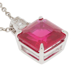 Emerald red ruby sterling silver pendant with moissanite accent, showcasing a vibrant gemstone in an elegant setting.