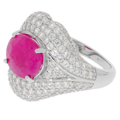 Oval red Moissanite ring in sterling silver, accented with sparkling stones, showcasing elegant design and luxury.