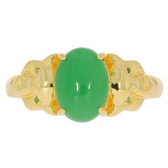 Oval green jade ring with gold band and intricate design, showcasing elegance and luxury.