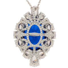 Oval blue sapphire pendant in sterling silver with intricate design and sparkling accents, reflecting luxury and elegance.