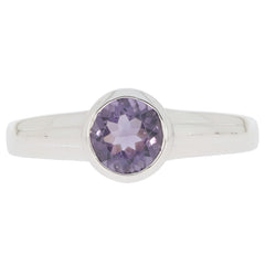 Sterling silver ring featuring a round purple gemstone at the center, elegant and modern design.