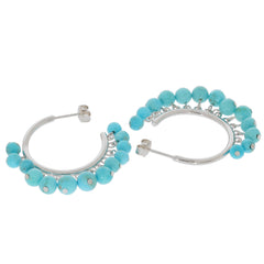 Blue turquoise sterling silver hoop earrings adorned with sparkling gemstones, perfect for an elegant look.
