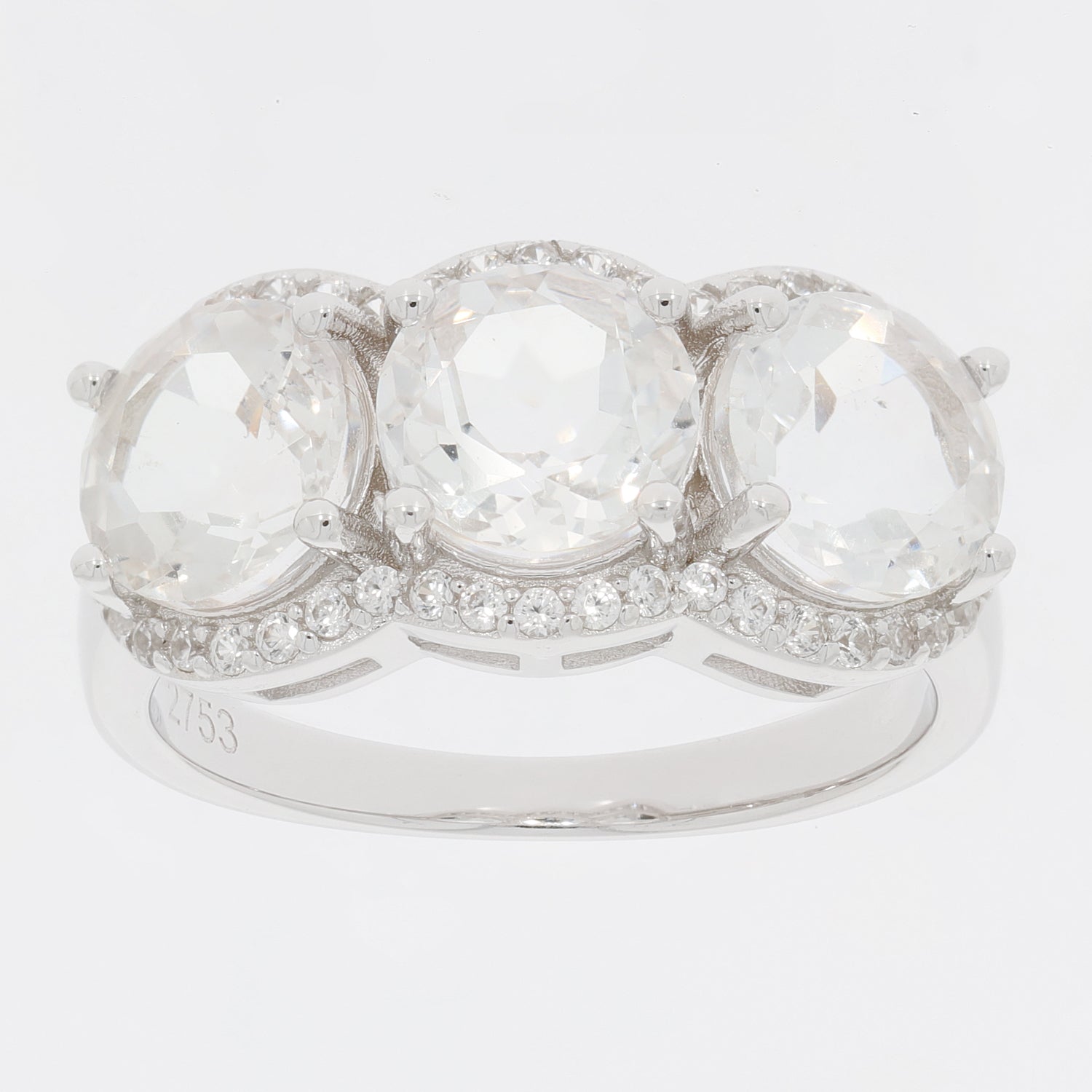 Round white Moissanite sterling silver ring with three sparkling stones and accent diamonds.