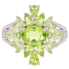 Elegant green peridot sterling silver ring featuring multiple pear and oval cut gemstones, a stunning statement piece.