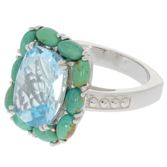 Cushion blue topaz sterling silver ring with turquoise accents, showcasing elegant gemstone design.