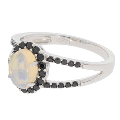Oval white opal sterling silver ring with black diamond accents, showcasing elegance and luxury in jewelry.