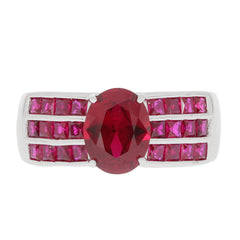 Oval red ruby sterling silver ring with ruby accent, featuring a central oval gemstone and sparkling ruby side stones.