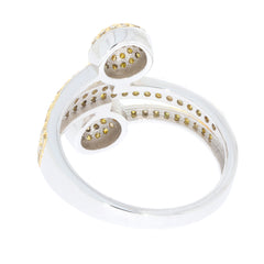 Elegant silver ring featuring intricate design with yellow accents and gemstone detailing.